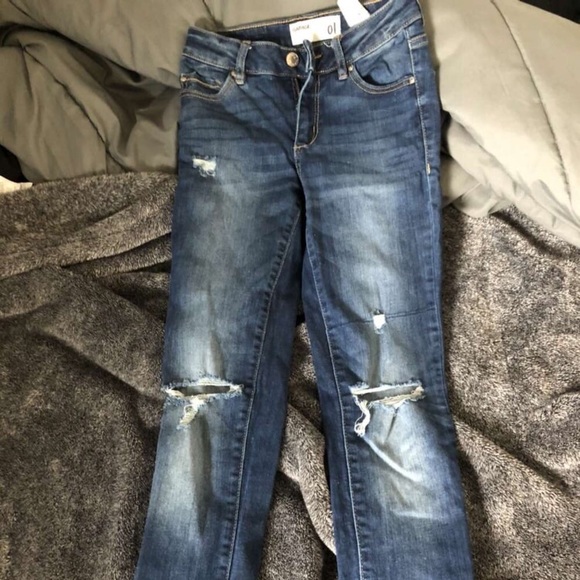 dark blue garage jeans, rips in the knees. size 1